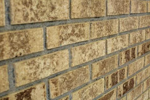 Beige brick facade on house at angle Stock Photos