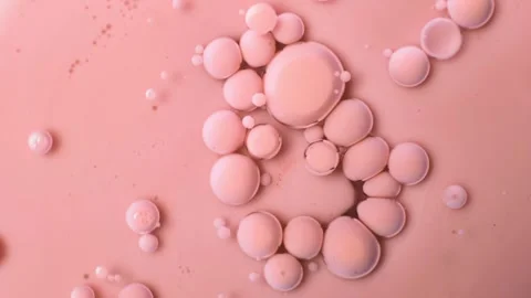Beige bubbles of paint on an oil surface. Acrylic paint. Abstract background. Stock Footage 266973739