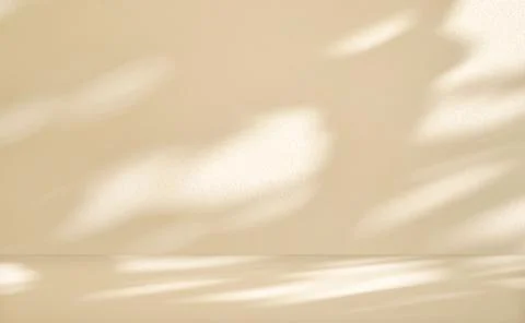 Beige cement wall in empty room with light and shadow. Stock Photos