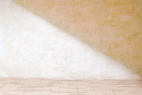 Beige cement wall in empty room with light and shadow. Stock Photos