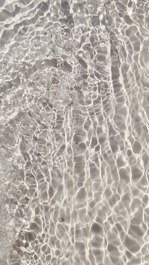 Beige clear water surface texture background with many splashes and bubbles. Ver Stock Footage 340405611