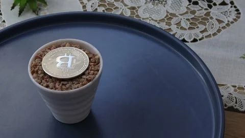 Beige colored pebbles inside the physical bitcoin Stock Footage 248613690