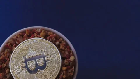 Beige colored pebbles inside the physical bitcoin Stock Footage 248614400