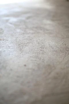 Beige Concrete Texture Close-Up with Subtle Light Gradations Foto stock