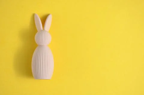 Beige Easter bunny on a yellow background. Stock-Fotos