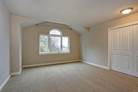 Beige empty room interior with built in closet, carpet floor and large window Stock Photos