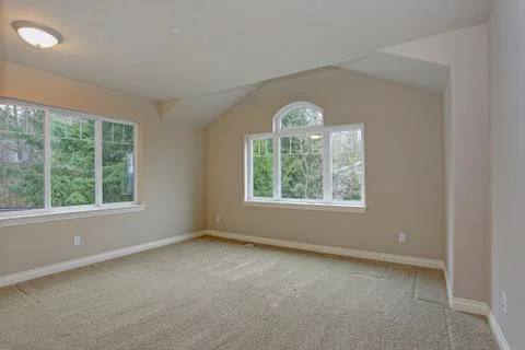 Beige empty room interior with built in closet, carpet floor and large window Stock Photos