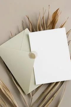 Beige envelope with blank paper card mockup inside top view on beige background  Stock Photos