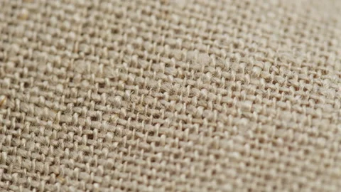 Beige fabric close-up, light brown cloth texture background. Macro shooting of Stock Footage 168556968