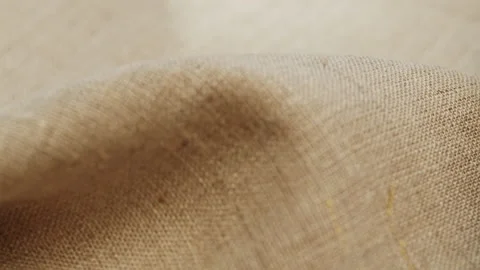 Beige fabric close-up, light brown cloth texture background. Macro shooting of Stock Footage 168557370