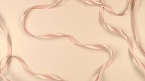 Beige festive delicate pastel background with satin ribbons, the concept of the Stock Footage 222911201