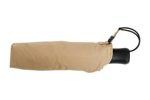 Beige folding umbrella in protective case. Compact portable accessory for r.. Photos