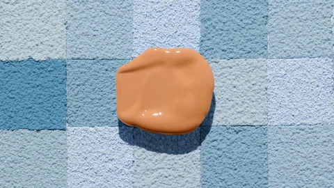Beige foundation blob with shadow on blue mosaic surface Stock Footage 337470303