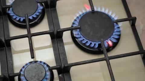 Beige gas cooking panel with burning camphors, view from above, left to right Stock Footage 153461097