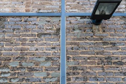 Beige half timbered brick wall with a lamp Foto stock