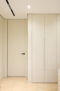 Beige interior door with wardrobe Stock Photos