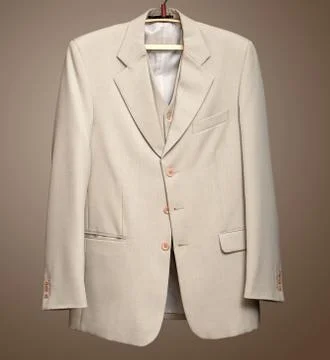Beige jacket on hanger with clipping path Stock Photos
