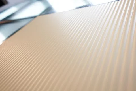 Beige kitchen cabinets with wavy texture. Glass inserts. Push mechanism, without Stock Photos