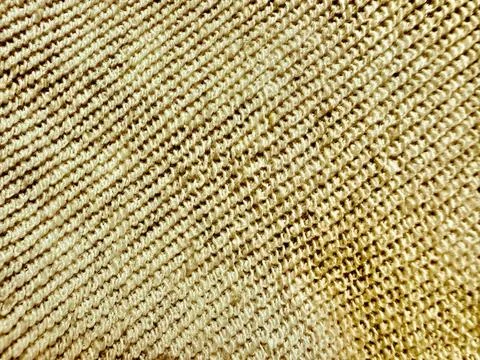 Beige knit texture macro closeup soft wavy ribbed fabric cozy warm material.. Stock Photos