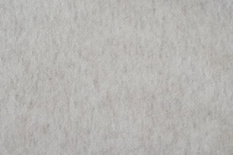 Beige knitted background with a fine pattern. Knitted wallpaper. Beige knitte Stock Photos