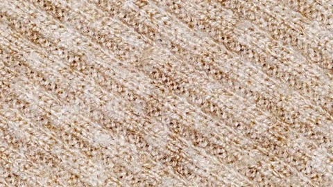 Beige knitted fabric close-up with diagonal seams, moving sideways Stock-Footage 246851333