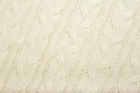 Beige knitted fabric wool texture for background. Close up of White Knitted m Stock Photos