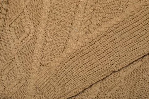 Beige knitted texture with a pattern Stock Photos