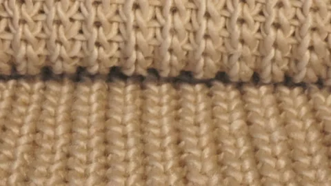Beige knitted wool background. Blanket made of beige smoky wool 動画素材 109182335