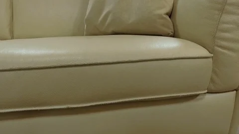 Beige leather sofa with pillows. Close-up Stock Footage 75732818