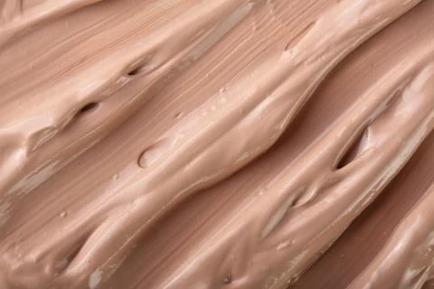 Beige liquid foundation makeup as a background. Top view. Flat lay pattern Foto stock