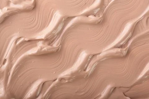 Beige liquid foundation makeup as a background. Top view. Flat lay pattern Foto stock