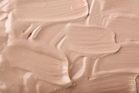 Beige liquid foundation makeup as a background. Top view. Flat lay pattern Foto stock