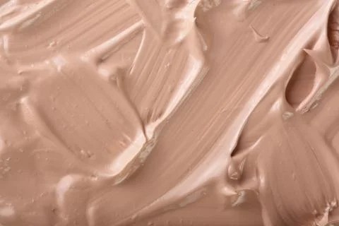 Beige liquid foundation makeup as a background. Top view. Flat lay pattern Foto stock