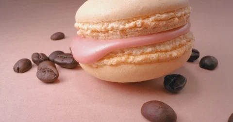 Beige Macaron With Coffee Beans On Pink Background. Macro. Stock Footage 108923199