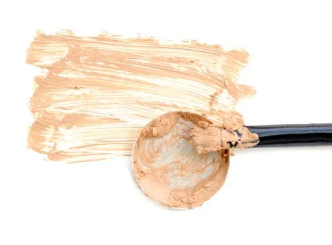 Beige make up foundation with brush close up isolate on white. Stock Photos