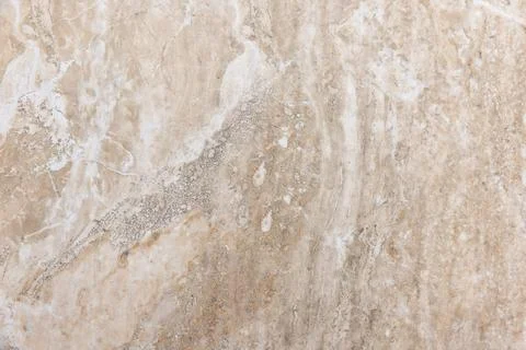 Beige marble surface with subtle veins and organic mineral patterns Stockfoto's
