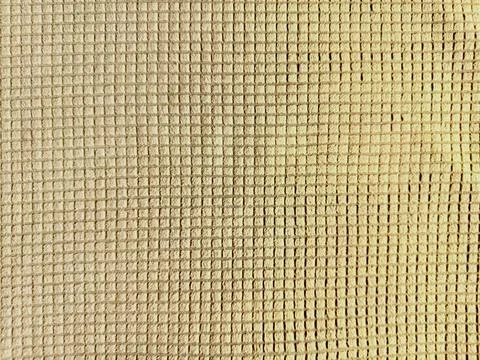 Beige mesh fabric grid texture close up reveals uniform square pattern in ser Stock Photos
