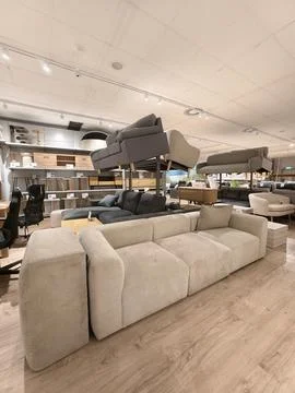 Beige modular sofa on display in a modern furniture department store showroom Stock Photos