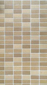 Beige Mosaic Tile Wall with Small Rectangular Tiles Background Stock Photos