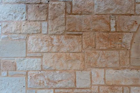 Beige natural stone wall texture background closeup Fotos Stock