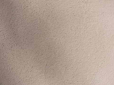 Beige painted wall. Rough light brown texture. Stock Photos