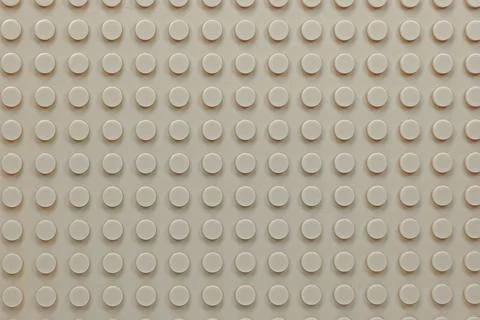 Beige plastic constructor blocks plate Stock Photos