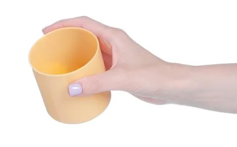 Beige plastic cup mug in hand Stock Photos