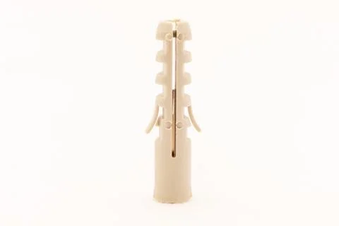 A beige plastic wall plug is shown against a white background. Stock Photos