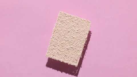 Beige powder rectangle casting shadow on pastel pink Video stock 337117166