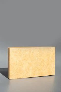 Beige rectangular building block on gray background Fotos de archivo