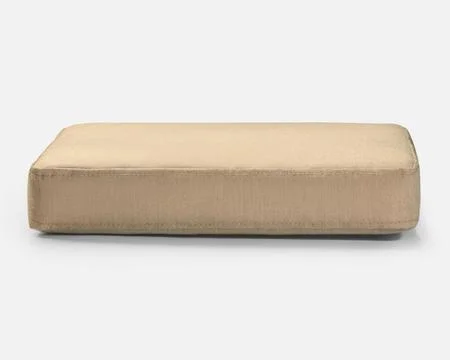 Beige rectangular cushion resting on white surface Stock Photos