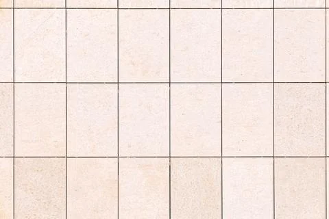 Beige rectangular stone tiles forming a seamless grid pattern, creating a n.. Stock Photos
