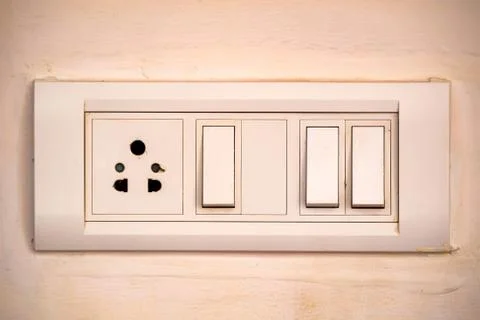Beige rocker light switch with three buttons Foto stock