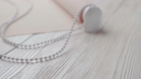 Beige roller blind and spare parts on a white wooden table. Stock-Footage 147961849